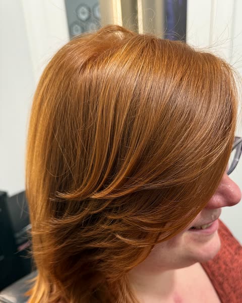 Copper hair color on a layered, shoulder-length cut at Will Vazquez Beauty Bar, Orlando