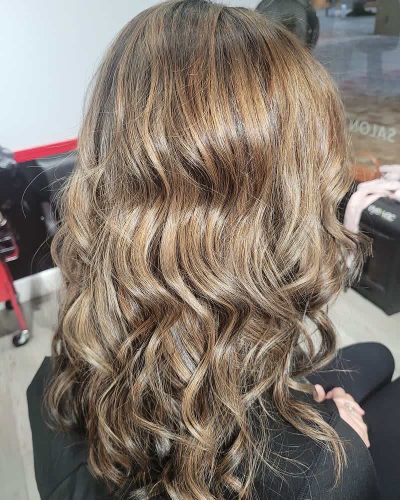 Brunette hair with caramel highlights, finished with loose curls at Will Vazquez Beauty Bar, Orlando