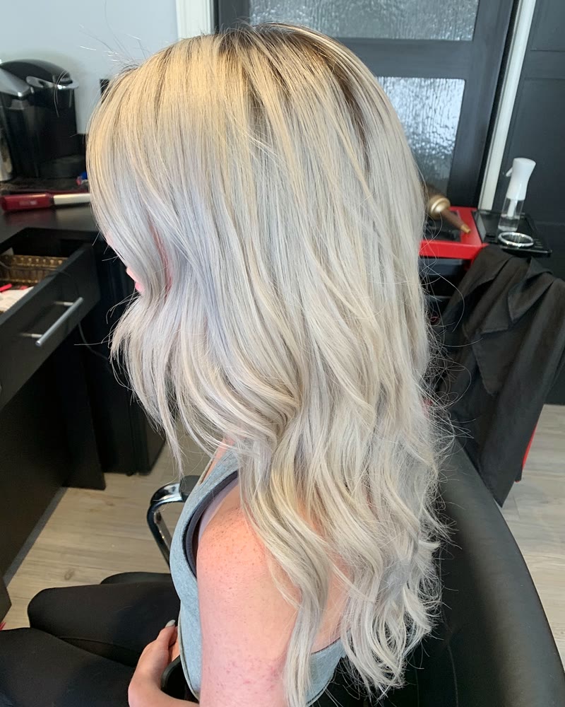 Icy platinum blonde hair with a shadow root, styled in loose waves at Will Vazquez Beauty Bar, Orlando