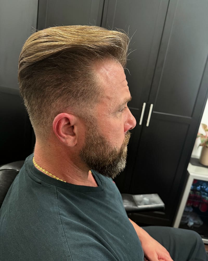Men's haircut with short tapered sides, a swept-back top and a groomed beard at Will Vazquez Beauty Bar, Orlando