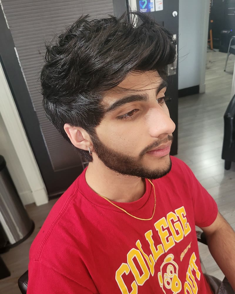 Textured men's haircut with volume on top on thick dark hair, with a shaped beard at Will Vazquez Beauty Bar, Orlando