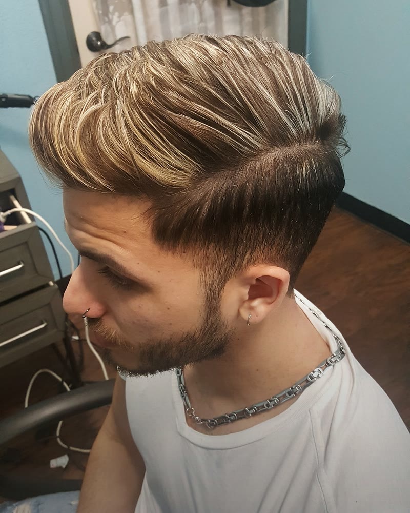 Men's haircut with a short taper and a longer top with blonde highlights, styled to the side at Will Vazquez Beauty Bar, Orlando
